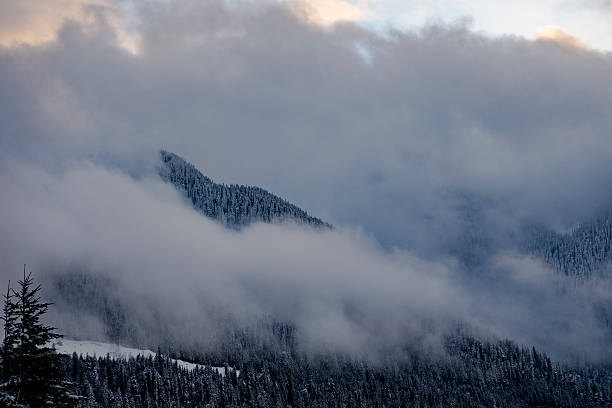 istock Hillside Peeks Out From Behind Snow Clouds as They Dissipate 544001780