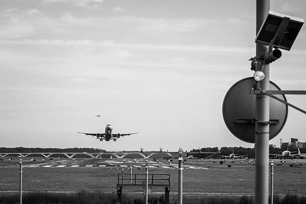 Boston, United States – August 31, 2022: A grayscale shot of a Condor airplane taking off from a tarmac runway at an airport