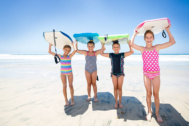 istock Kids playing at the beach together while on vacation 544004210