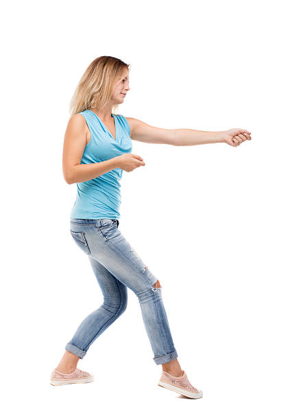 istock back view of standing girl pulling  rope from top 544099444