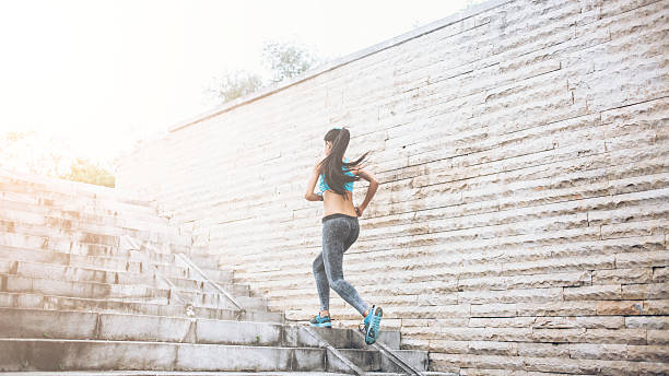 istock Young woman running up stairs 544099512