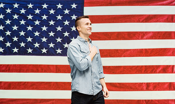 istock Cheerful man in front of flag 544100358