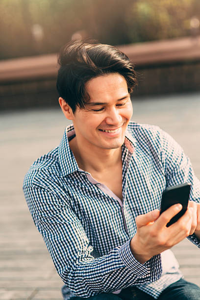 istock Young japanese man texting on the phone 544102734