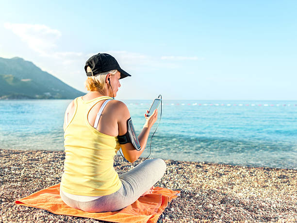 istock Exercising woman outdoors with smartphone 544104500