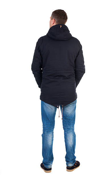 istock Back view of handsome man in winter jacket  looking up. 544104760