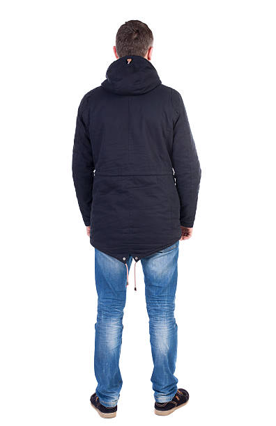 istock Back view of handsome man in winter jacket  looking up. 544105282