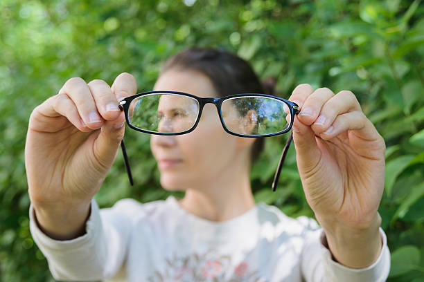istock thinking young woman holding glasses 544105532