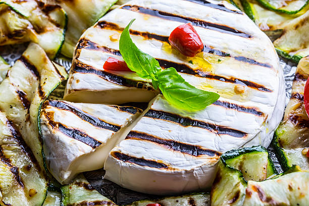 Grill Brie camembert cheese zucchini with chili pepper.
