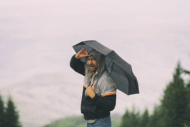 istock Man in nature holding umbrella. 544105836