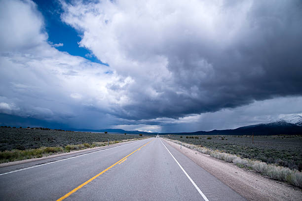 istock Storm clouds and endless staight road in Nevada 544106460