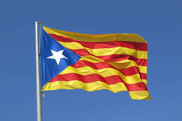 Catalan flag separatist independence flag waves in blue sky stock photo
