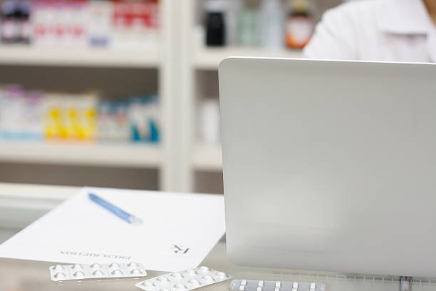 istock Pharmacist with laptop computer and medication in the pharmacy 544107530