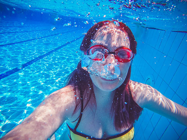istock Female swimmer gushing through water in pool 544107982