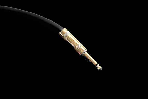 istock Audio instrumental cable with golden jack isolated on black 544109088
