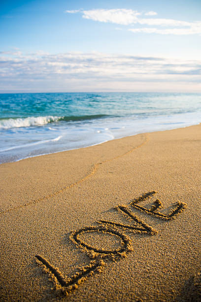 istock word love written in sand on the beach 544109514