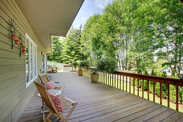 istock Wooden walkout deck with chairs and flower pots . 544110848