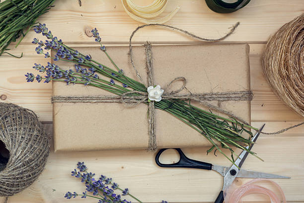 istock Gift box decorated flowers on wooden background, view from above 544112420