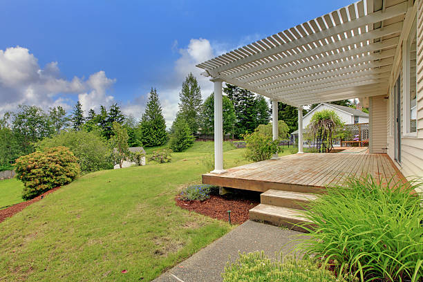 istock Wooden front deck of home with green lawn 544114866