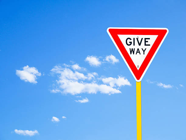 istock Give way sign on blue sky (with clipping path) 544115040