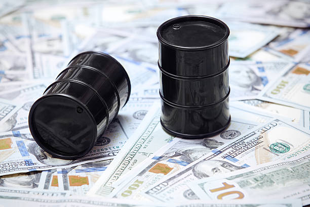 Oil drums on US dollars background stock photo