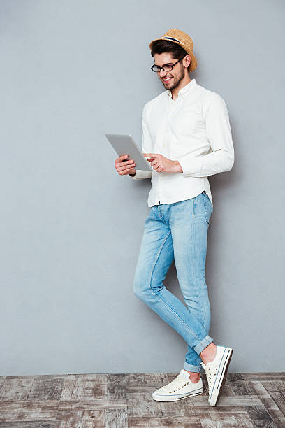 istock Full length portrait of a happy man using tablet computer 544116588