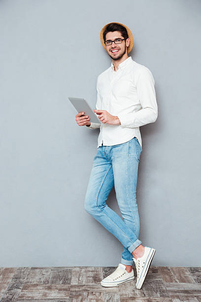 istock Full length portrait of a happy man using tablet computer 544117552