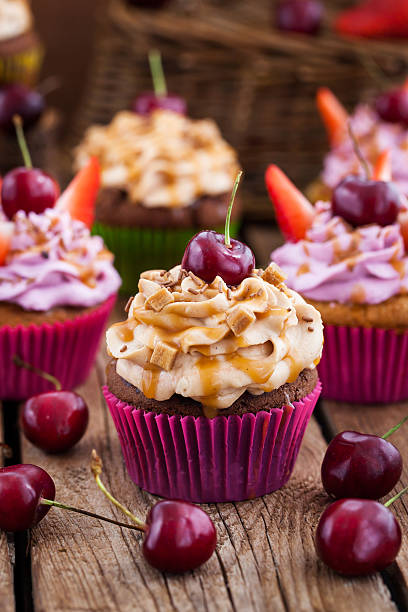 istock Delicious cupcakes decorated with caramel and fresh berries 544120326