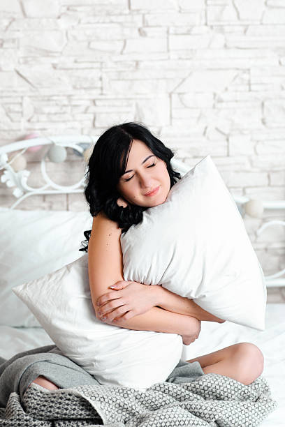 istock Dreaming relaxed woman hugging pillow 544121390