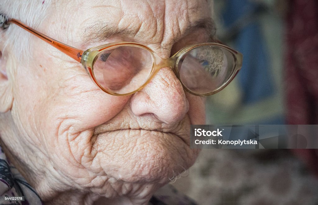 Old age and sadness. Portrait of an elderly woman Portrait of an elderly woman. Expressive facial features. Kindness and mercy. Assisting the elderly in old age Blindness Stock Photo