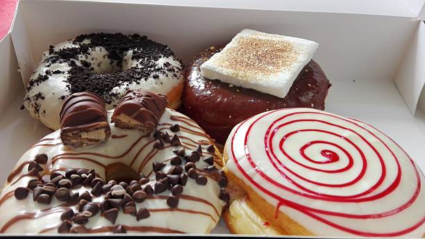 istock cookies and cream, marshmallow, strawberry white chocolate donuts 544123008