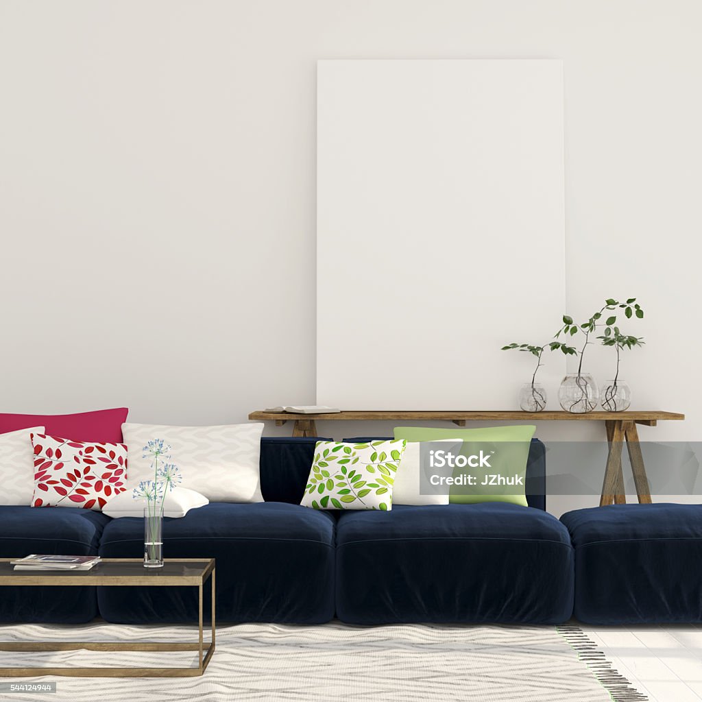 Blue sofa and a wooden console with a canvas Wide blue sofa with colorful pillows and a wooden console with a large canvas on it Domestic Room Stock Photo