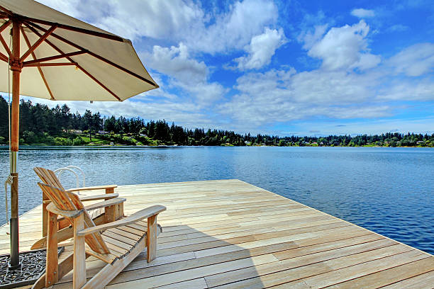 istock Two adirondack wooden chairs with umbrella 544125546