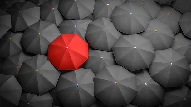 istock Leadership or distinction concept. Red umbrella and black umbrellas around. 544125714