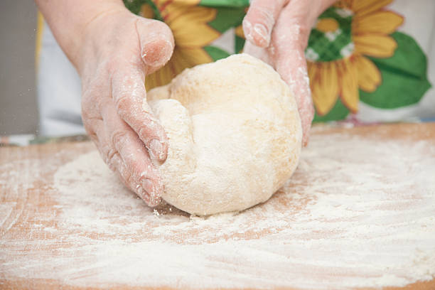 istock Women's hands preparing fresh yeast dough 544126174