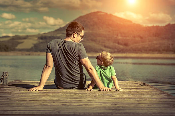 istock Father and son on the pier at sunny day sunlight 544128312