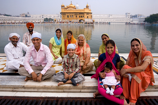 Amritsar, India - October 24, 2006: A family of Sikh pilgrims at the Golden Temple of Amritsar in the town of Amritsar in the Punjab region of India. The Golden Temple (Harmandir Sahib) is the holiest shrine in Sikhism.