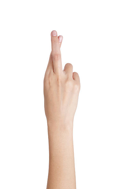 istock Woman's hand gesturing crossed fingers with back side. 544131524