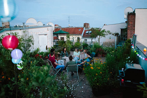 istock young adults, roof garden, talking, smoking Hookah 544132006
