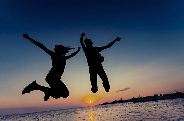 istock Silhouette Beautiful couple are having fun jumping 544139648