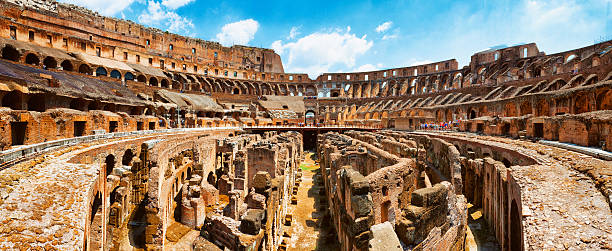 Panoramic Interior of The Colosseum in Rome, Italy Panoramic shot of the interior of The Colosseum (Flavian Amphitheatre) in Rome, Italy. The Colosseum was constructed in the 1st century AD. Multiple files stitched. inside the colosseum stock pictures, royalty-free photos & images