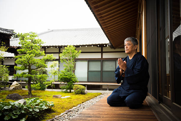 istock Senior man meditating at a temple 544310786