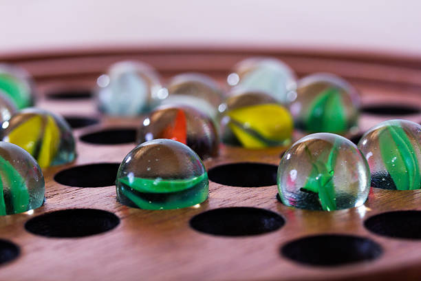 Close up of marbles in a solitare game stock photo