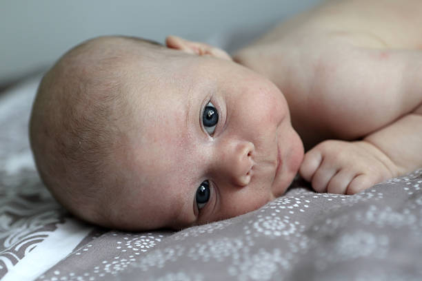 istock Pensive baby boy on a bed 544313984