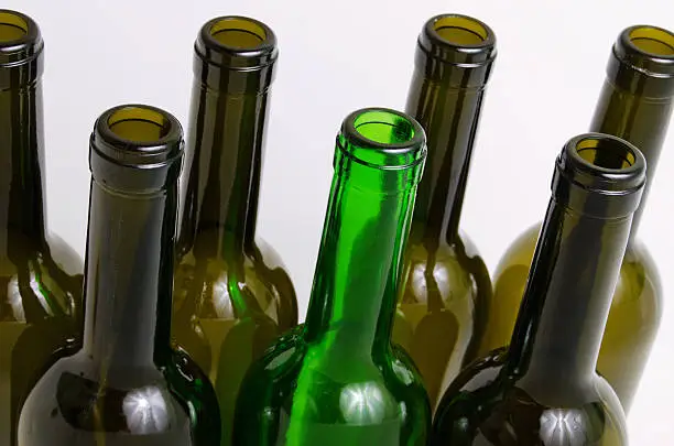 Empty bottles of wine on a light background.