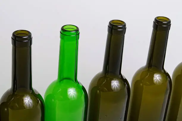 Empty bottles of wine on a light background.