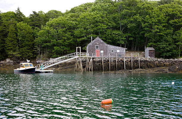 Fisherman's pier and boat in Maine harbor. Typical New England coastal scenery.