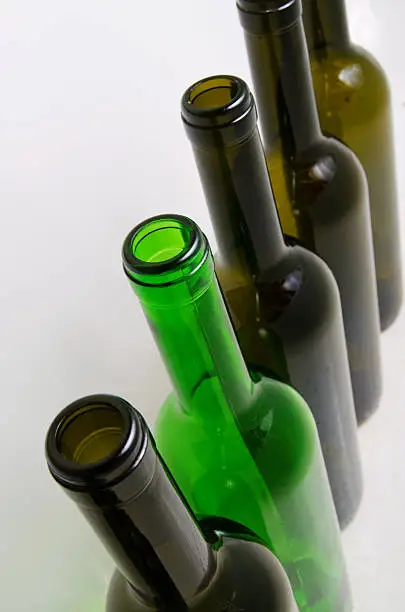 Empty bottles of wine on a light background.