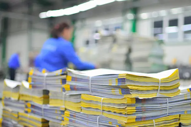 Photo of stuck of newspaper magazine in print production process