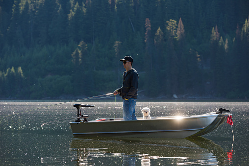 Fly fishing from a boat on a stunning mountain lake