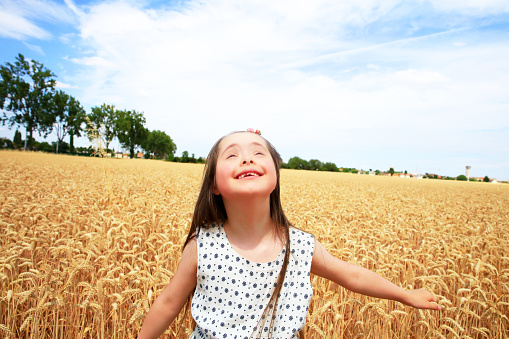 Young girl have fun in the wheat field